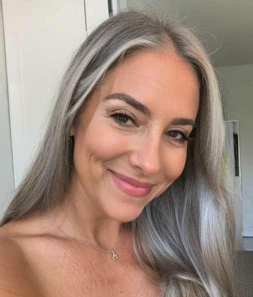 Straight silver long hair on smiling woman over 60