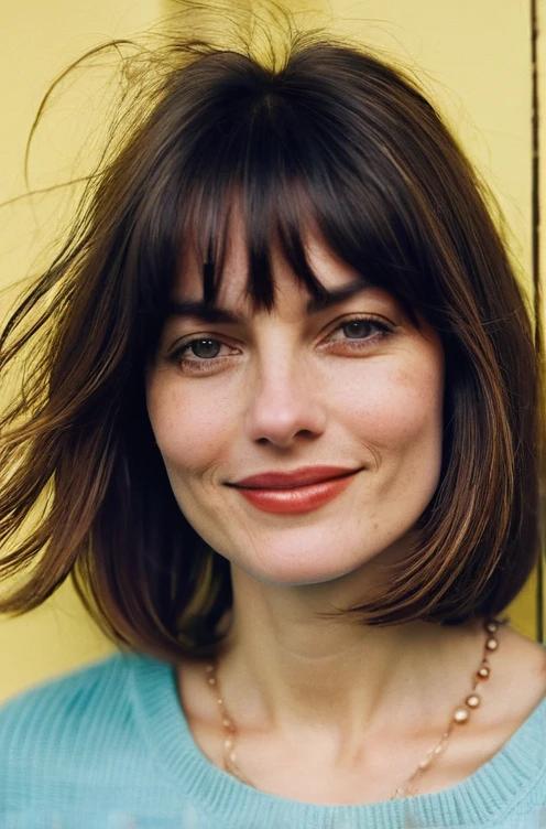 A choppy long bob with curtain bangs that adds a trendy, textured style.