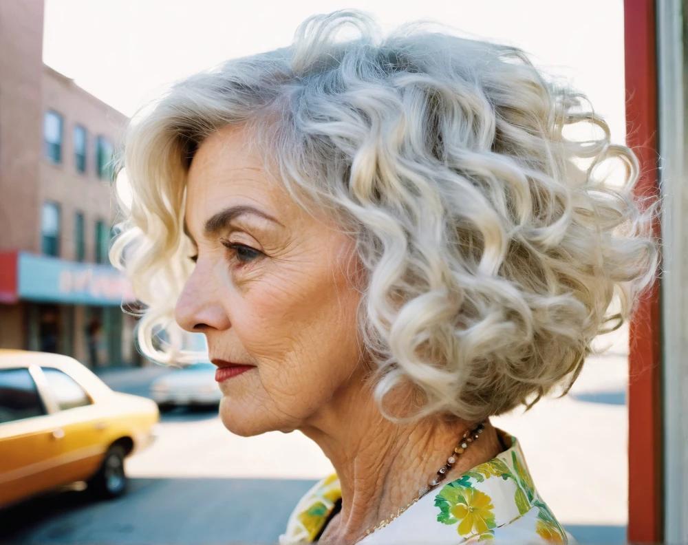 Layered white curly bob for a 60-year-old woman, embracing natural curls with a soft, sophisticated look.