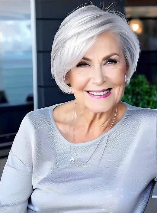 Trendy silver angled bob medium-length hairstyle for women over 60, with a sleek and modern angled cut